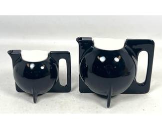 Lot 887 Pair of Modernist Ceramic Black Glazed Teapots with Contrasting White Lids and FinLike Bases. Unsig