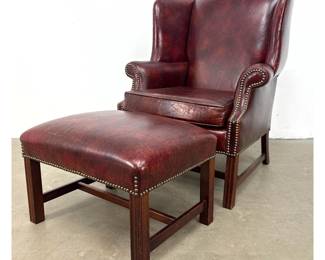 Lot 1089 Classic Leather Inc. Wingback Lounge Armchair and Matching Ottoman in Oxblood Leather. Signed with L