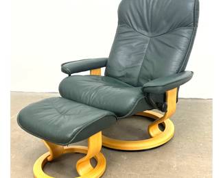 Lot 1079 Ekornes Stressless recliner and matching ottoman in green leather with bentwood swivel base. Made in