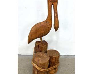 Lot 1033 Large Stylized Hand Carved Laminated Wood Pelican Sculpture. Stands on Dock Piling Base with Real Ro