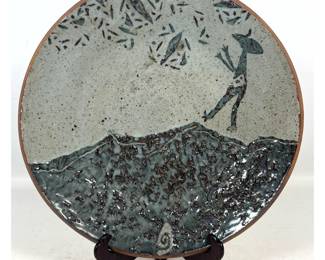 Lot 901 Artist Signed Stoneware Charger. Figure on mountain.