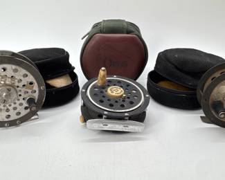 Trio of vintage fly fishing reels with cases