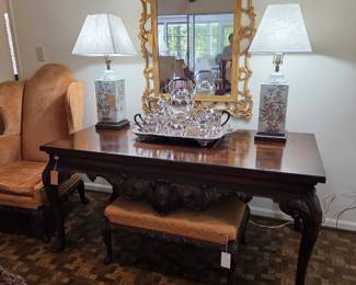 Grand Scale Berkey & Gay Table, circa 1910, Berkey & Gay Queen Anne revival wingback chair, Berkey & Gay bench.  Chippendale Style gilt mirror. English silver plate tea service.