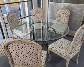 6 blanc bois upholstered side chairs & round glass table with metal base.
