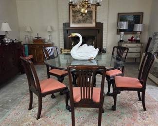 Glass Top pedestal table with 6 side chairs and two armchairs.  Persian wool carpet.
