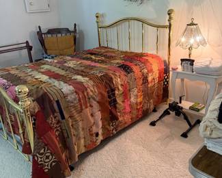 Brass bed with heavy handmade quilt