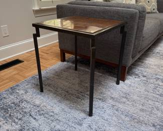 F10 - $200. PAIR of heavy metal framed side tables by Robert Augstell. . Wooden tops have uneven lacquer finish. Measures  20" square x 22.5" tall. 