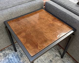 F10 - $200. PAIR of heavy metal framed side tables by Robert Augstell. . Wooden tops have uneven lacquer finish. Measures  20" square x 22.5" tall. 