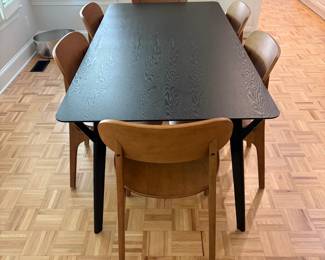 F61 - $300. Black Dining Room Table with 6 Wooden Chairs. All are newer and made to look like MCM furniture! Table measures 71" x 35.5" x 29.5" tall. Chairs are 19.5" wide x 21" deep x 33.25" tall. Seat to floor is 18".  Excellent condition and very gently used!