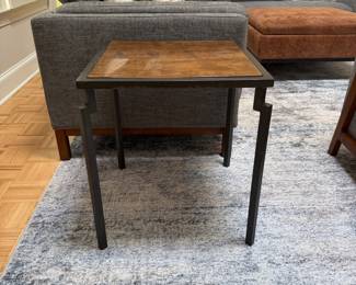F10 - $200. PAIR of heavy metal framed side tables by Robert Augstell. . Wooden tops have uneven lacquer finish. Measures  20" square x 22.5" tall. 