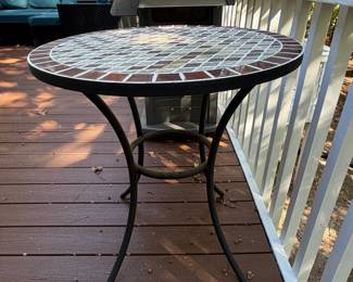 F64 - $50. Outdoor Iron Base & Tile Top Table. Measures 28" x 29" tall. Very solid. 