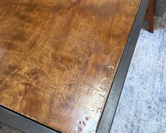 F10 - $200. PAIR of heavy metal framed side tables by Robert Augstell. . Wooden tops have uneven lacquer finish. Measures  20" square x 22.5" tall. 