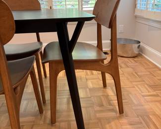 F61 - $300. Black Dining Room Table with 6 Wooden Chairs. All are newer and made to look like MCM furniture! Table measures 71" x 35.5" x 29.5" tall. Chairs are 19.5" wide x 21" deep x 33.25" tall. Seat to floor is 18".  Excellent condition and very gently used!