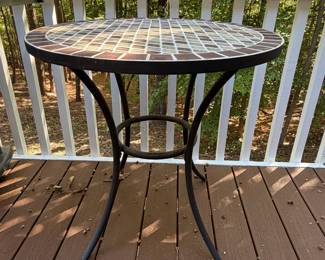 F64 - $50. Outdoor Iron Base & Tile Top Table. Measures 28" x 29" tall. Very solid. 