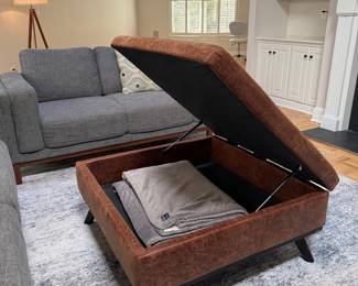 F8 - $125. Distressed Faux Leather Storage Ottoman. Top lifts to store blankets or remotes. Measures 36" square x 18" tall. 