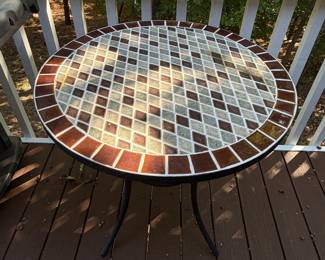 F64 - $50. Outdoor Iron Base & Tile Top Table. Measures 28" x 29" tall. Very solid. 