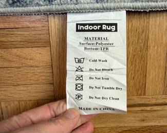 F11 - $100. Washable "Indoor Rug" with pad included. Measures approximately 10' x 14'. 