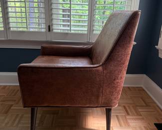 F18 - $75. Distressed Faux Leather Chair. Measures 27" x 28" deep x 35" tall. 