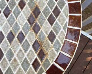 F64 - $50. Outdoor Iron Base & Tile Top Table. Measures 28" x 29" tall. Very solid. 