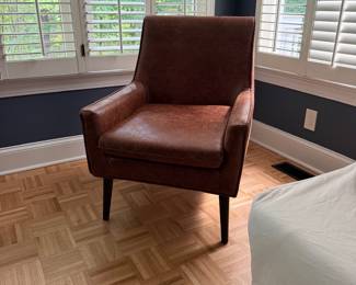 F18 - $75. Distressed Faux Leather Chair. Measures 27" x 28" deep x 35" tall. 