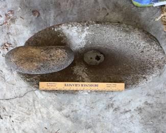 Native American grinding stone with hole in the bottom