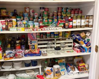 Pantry is overflowing with canned goods, pastas, spices and baking