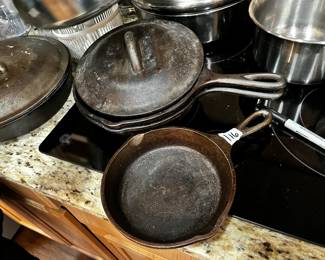 #116 Set of 3 Cast Iron Skillets Lodge - 6.5", 8", and 8" has one lid for 8" Skillets $25.00 #117 Lodge 10" Skillet w/lid $20.00