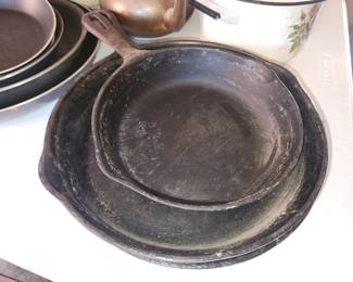 Assorted cast iron pots and pans
