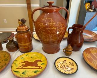 Large redware jar in center by Chris Woods, $300; redware small rooster plate, $25