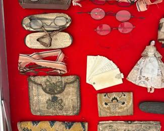 Showcase items include antique purses and antique spectacles