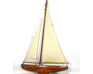 Lot 2009 Carved wood model pond yacht with weighted keel and original fabric sails. Unsigned.