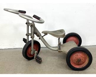 Lot 1731 Vintage heavyduty metal child s tricycle with spring suspension seat and loop style handlebars.