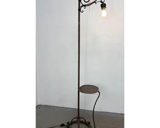 Lot 1734 Arts and Crafts wrought iron bridge floor lamp with integrated side table and dragon head terminal.