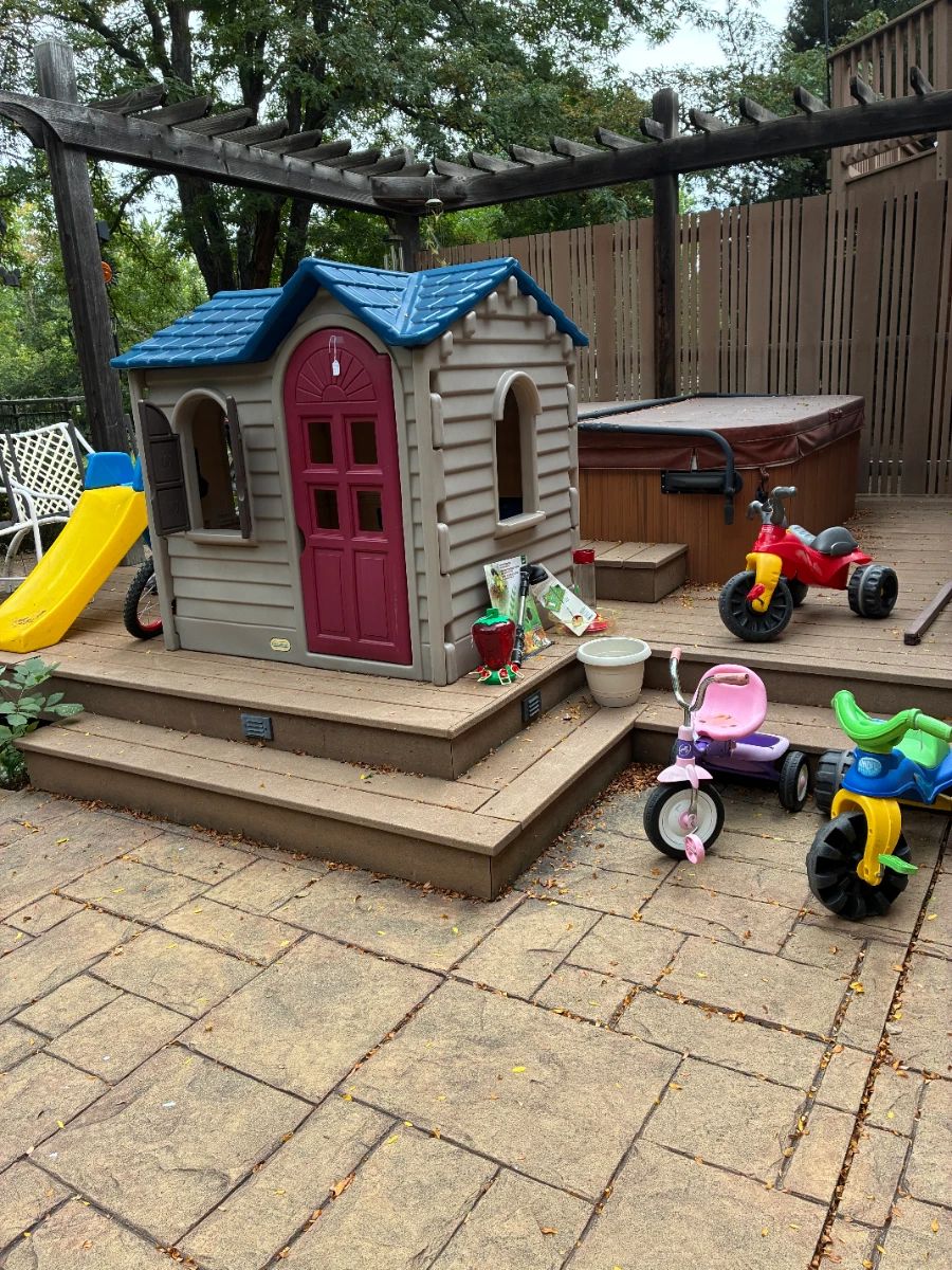 Children's playhouse, slide and trycycles