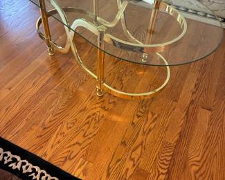 Brass base, oval glass top coffee table