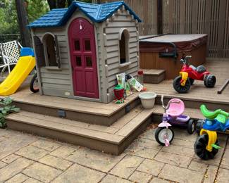 Children's playhouse, slide and trycycles