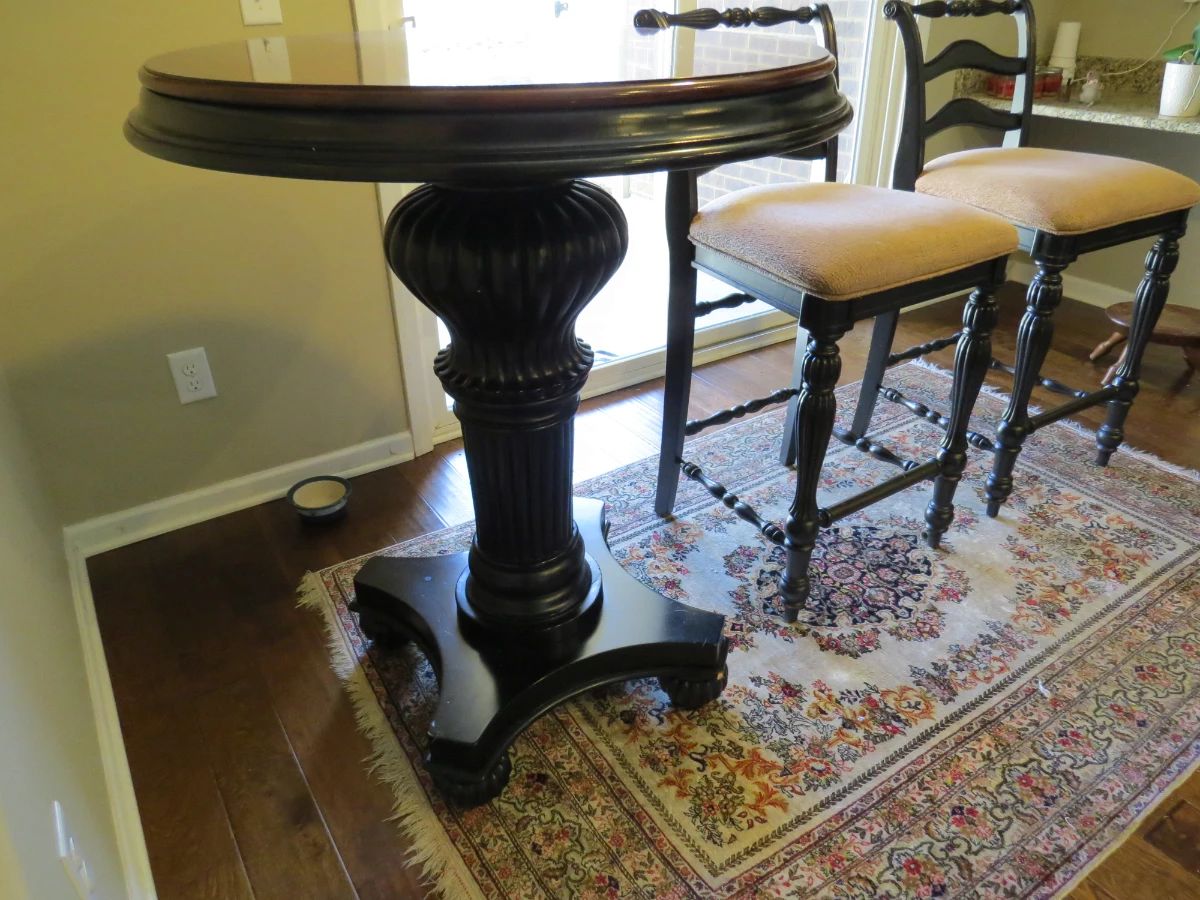 Bar height table and chairs. Oriental rug.