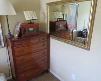 Chest of drawers. Mirror. Lamp. Bookstand. Record player with radio and CD. Various records.