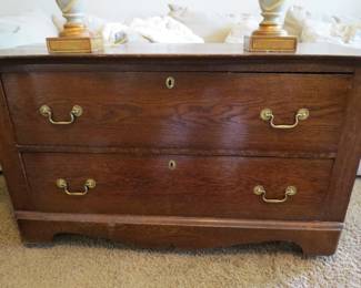 Chest of drawers. Sectional sofa in background.