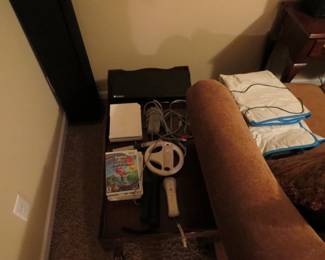 Wii console with games, steering wheel, controllers, and dance pad