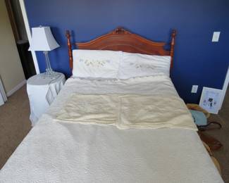 Bed, bedding, nightstand, and lamp