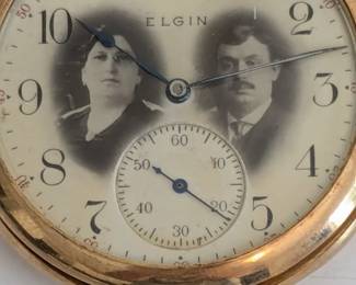 Elgin dial with inset sepia photographic portraits of a man and woman
