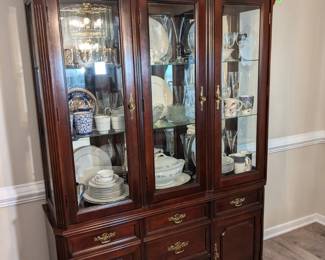 Bassett lighted china cabinet with broken-arch pediment