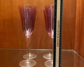 T121 - $40. Set of 4 Vietri Optical Amethyst Champagne Flutes. Each measures 10” tall.