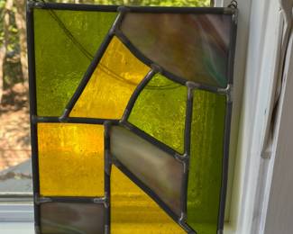 T104 - $30. Handcrafted hanging stained glass panel. Measures 7.5" x 9"T.