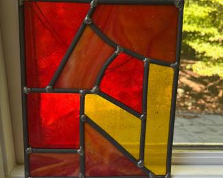 T103 - $30. Handcrafted hanging stained glass panel. Measures 7.5" x 9"T.