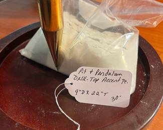 T35 - $30. Desktop Wood and Brass Pendulum and Pit. Measures 9" x 22" tall. Excellent condition.