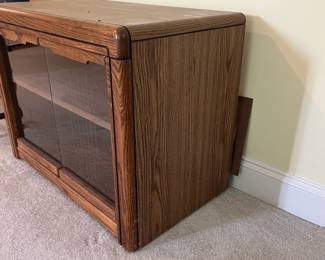 T47 - $10. Wood cabinet with glass doors and 1 adjustable shelf. Measures 28.5" x 16.5" x 22" tall. Good condition, but back needs to be reattached.