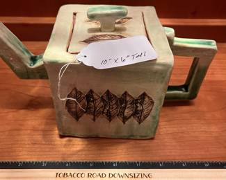 T25 - $25. Unsigned Pottery Teapot with Leaf Design. Measures 10" x 6" tall. Excellent condition.