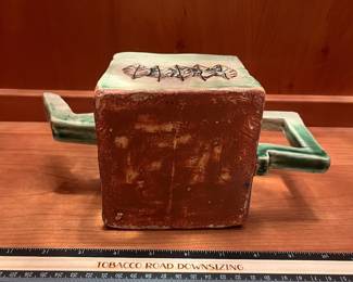 T25 - $25. Unsigned Pottery Teapot with Leaf Design. Measures 10" x 6" tall. Excellent condition.